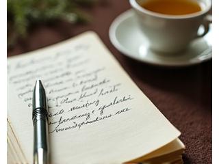 Person sketching or writing in a journal amidst calm surroundings, representing creative outlet and mental clarity.